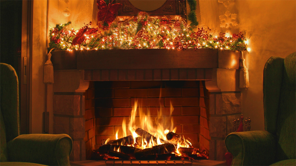 A roaring log fire in a cosy hearth, the mantelpiece decked with garland and lights