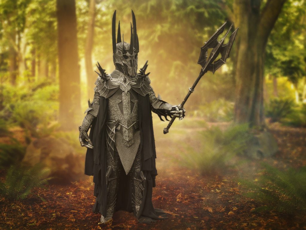 Fan Roger Perzan is seen in a woodland setting, dressed as Sauron from Peter Jackson's The Lord of the Rings movies, in Perzan's own cosplay build of full armour, complete with giant mace. 