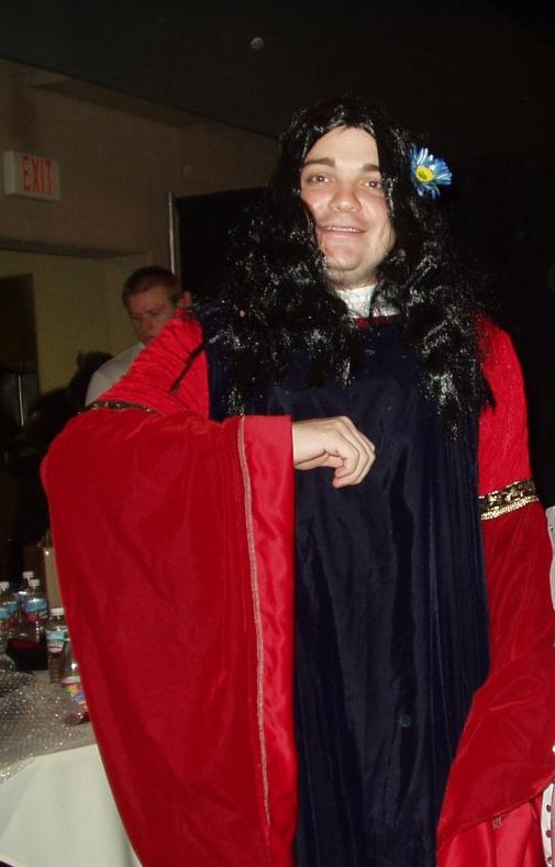 TORn founder Calisuri in a cosplay of Arwen's blue and red gown; with a lovely wig, and a flower behind his ear!