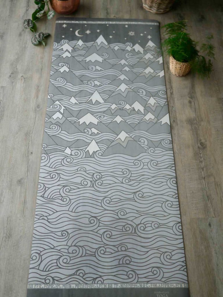 Photography of Middle-earth Yoga's 'Misty Mountains' yoga mat: a beautiful design in swirling grey tones, showing a stylised mountain range, with the moon and stars above. 