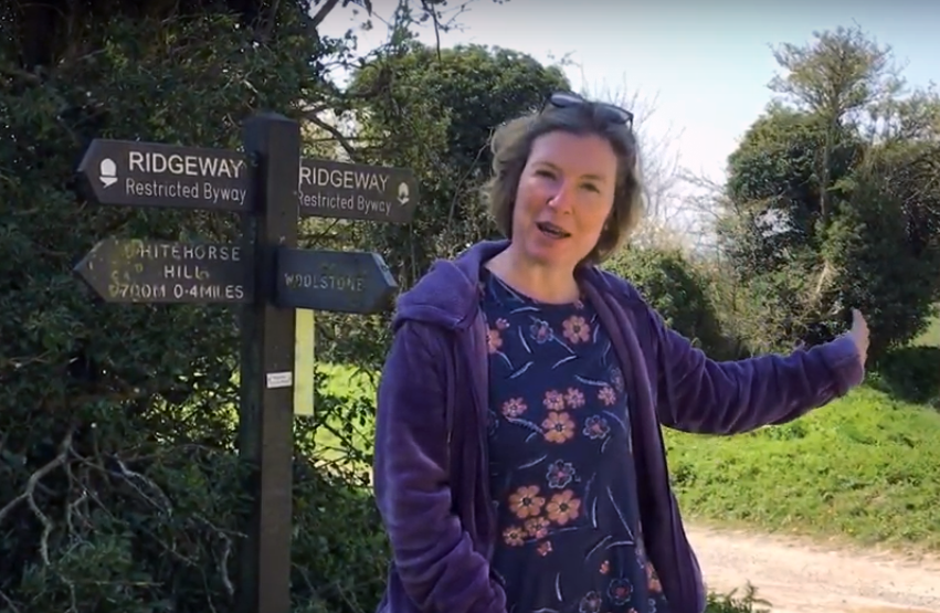 Julia Golding standing by a signpost on the Ridgeway in England.