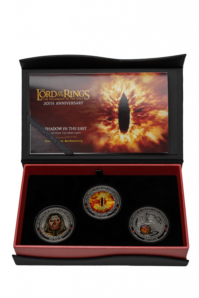Presentation pack for the 'Shadow in the East' set of coins. The inside lid of the box holds a certificate of authenticity, showing the Eye of Sauron; and the box holds three coins - Lurtz, Saruman with Palantir, and the Eye of Sauron.