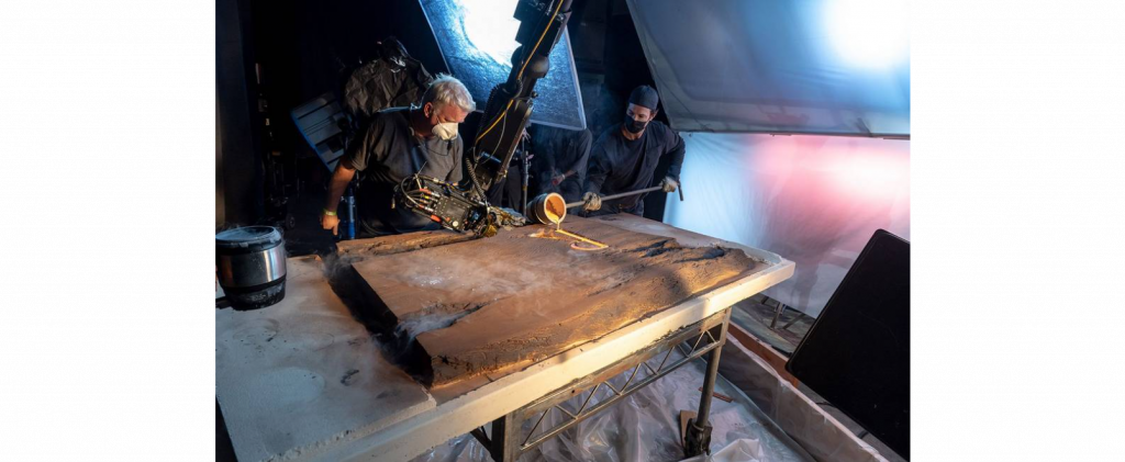 Camera operator gets in close at the red hot metal is poured in the R of RINGS