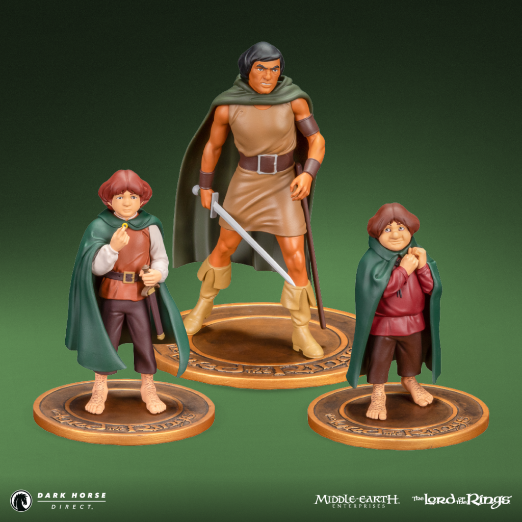Three LOTR action figures on round bases: a tall warrior with a sword between two hobbits in green cloaks, set against a green background.