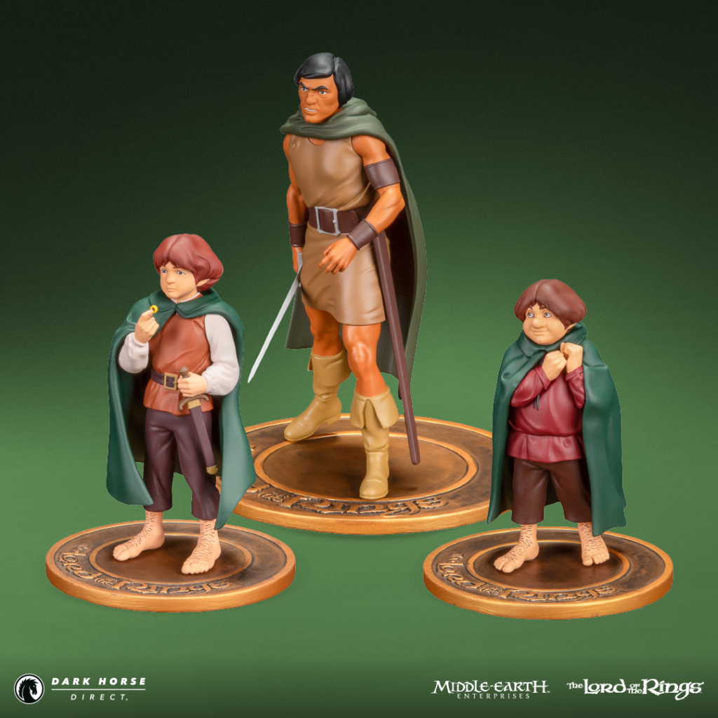 Three Lord of the Rings Hobbit action figures on round bases, with a tall central warrior and two smaller hobbits in green cloaks.