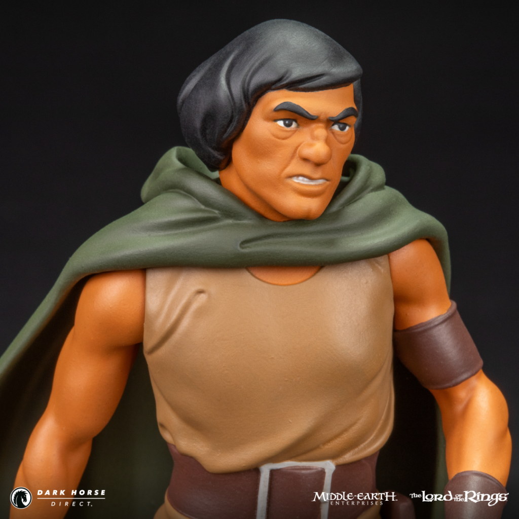 Action figure of Aragorn from The Lord of the Rings, wearing a green cloak and tan tunic with a brown belt.