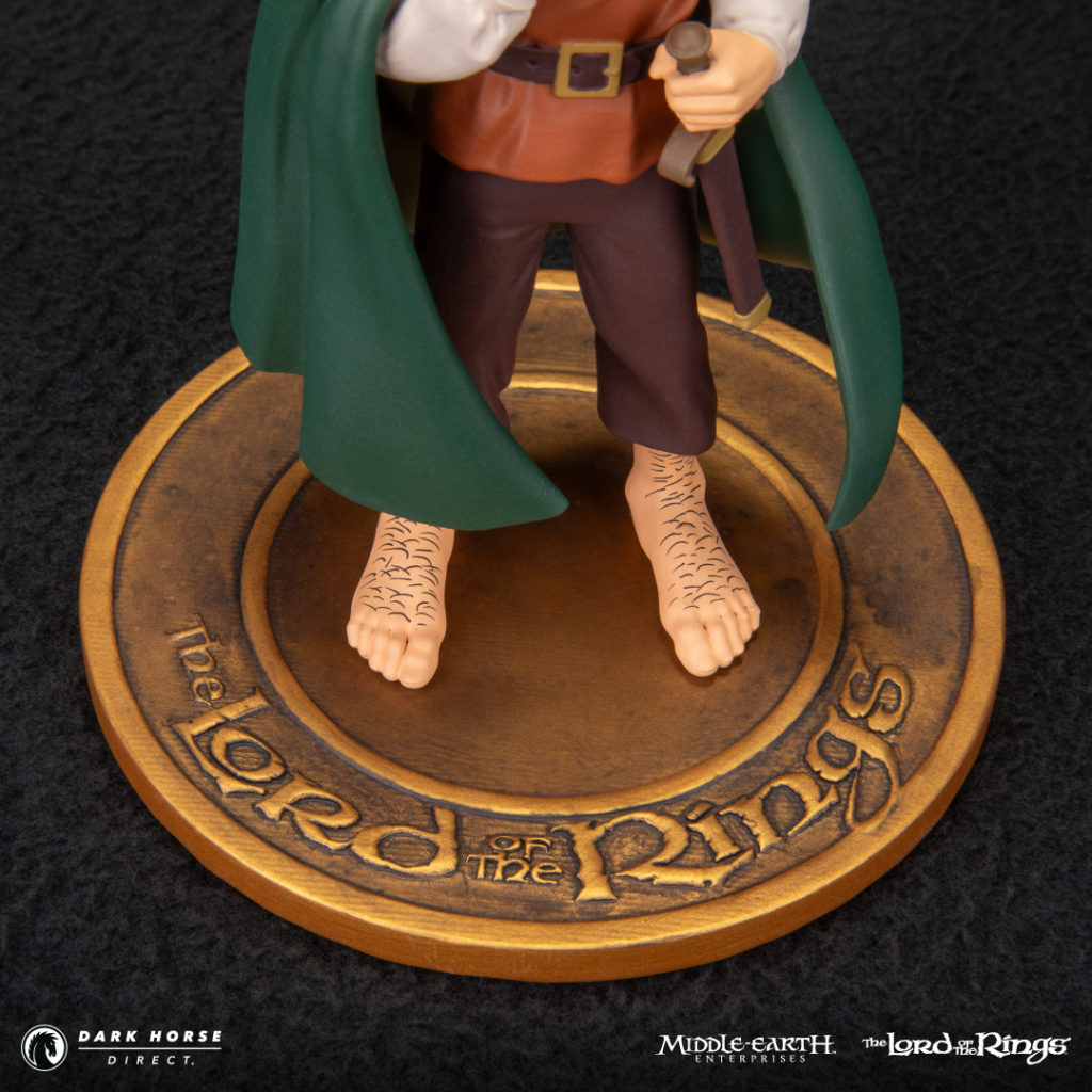 Gandalf action figure standing barefoot on a bronze circular base inscribed with The Lord of the Rings.